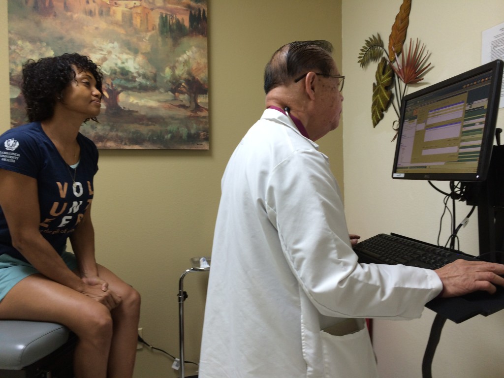 Patient Malaika Jacocks looks on as Dr. Romeo Rodriquez enters important information in LaSalle Medical Associates' Electronic Medical Records system. 